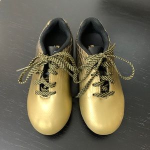 Gently used toddler girl gold and black cleats size 9